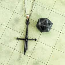 Broken Sword Necklace with Dice beside it